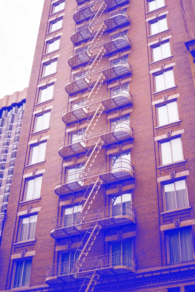 Photo shows a large multi-story building in California, with focus on the fire escape and the many stairs - used to symbolize the process of leaving the GoDaddy Website Builder platform for a more developed and enterprise platform like WordPress